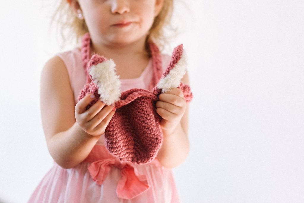 Little girl holding a Bobble Bunny Bag made using this free Easter crochet pattern